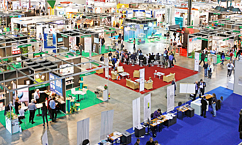 An overhead view of a vast trade show in progress,