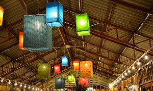 Lanterns of varying colors light up the ceiling of an event.