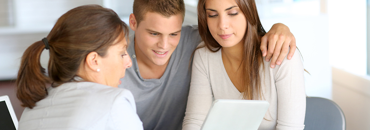 A young couple is meeting with a financial advisor.