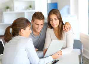 A young couple is meeting with a financial advisor.