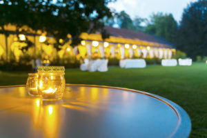Outdoor wedding tent in evening, candlelit table