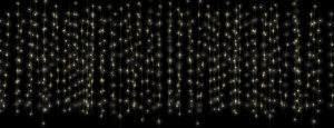 A curtain of string fairy lights on a dark background.