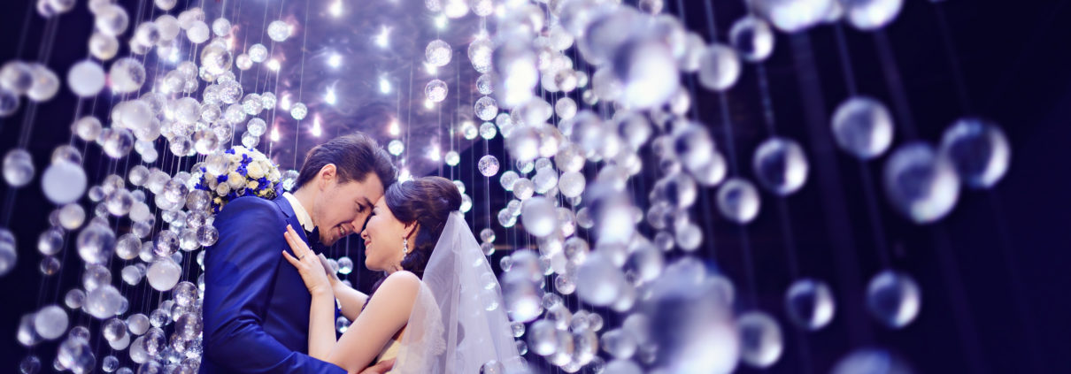 Married couple in atmospheric lighting.