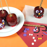 An image of candy apples and the Halloween-themed decorations meant to go on them.